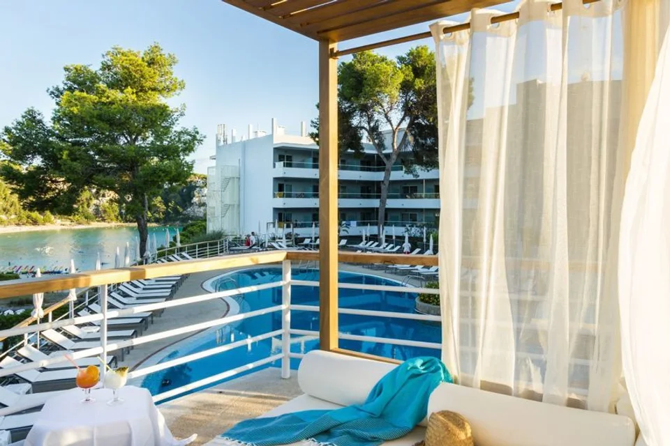 Piscina e edifício do ARTIEM Audax, vistos de uma varanda em Cala Galdana.